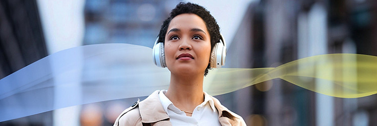 Two business people standing in front of a large window, discussing work.