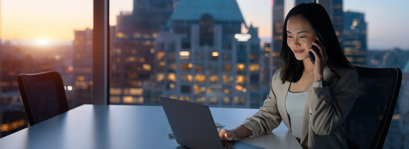 A woman using laptop and also mobile