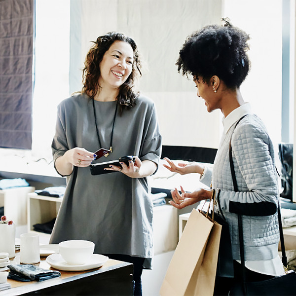Two woman smiling each other