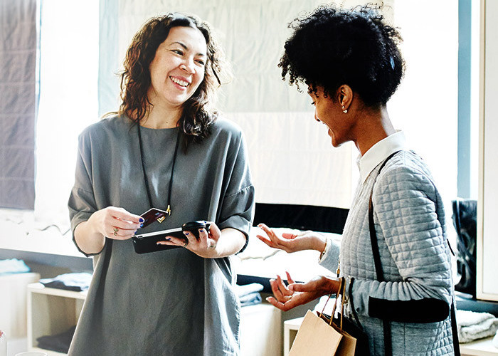 Two women engaged in a discussion at the office.