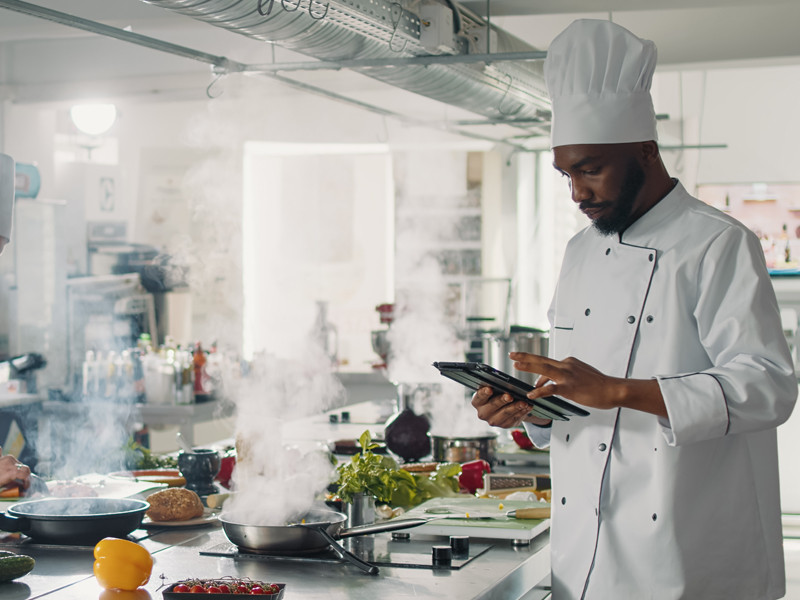 A chef is using Ipad