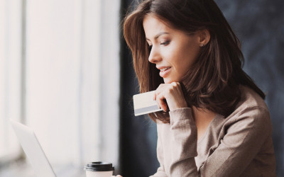 A woman making a digital payment holding a bank card