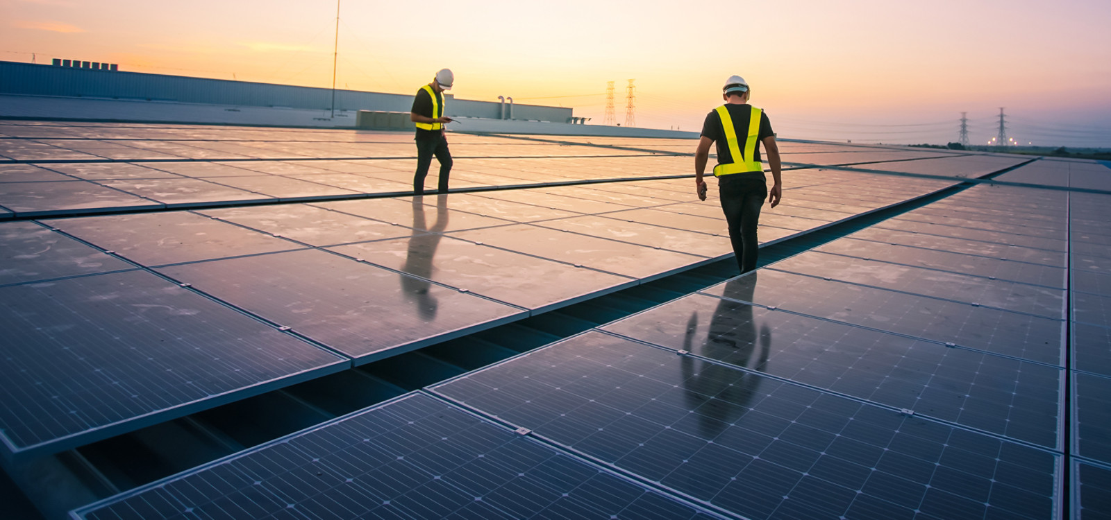 Two men working on solar panels