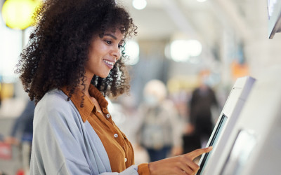 A woman interacting with a kiosk