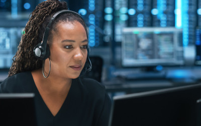 A women using headphones and watching laptop