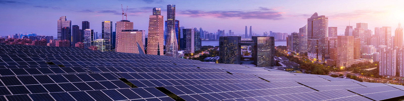 Solar panels on the roof of a residential urban area at sunset.