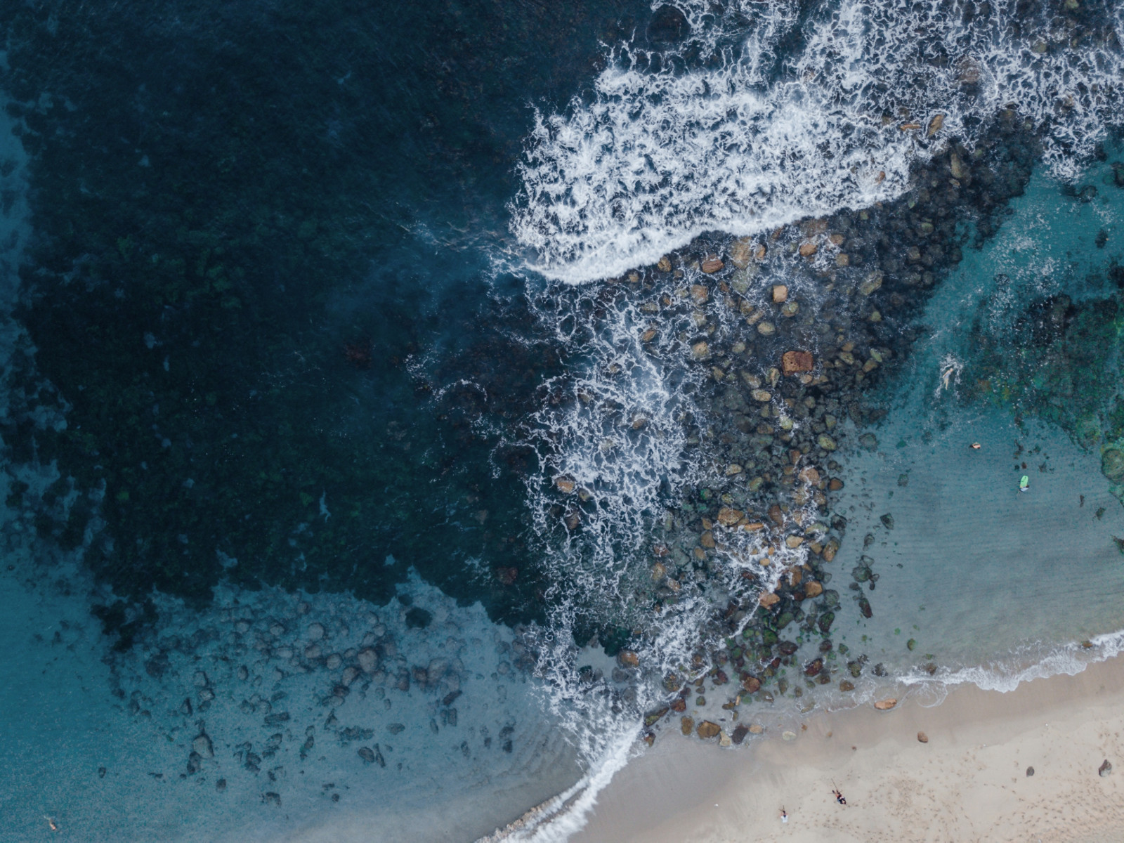 Rocky shallow water viewed from above.