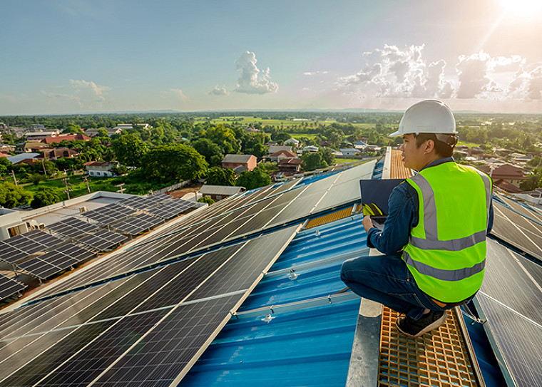 A solar engineer on a rooftop