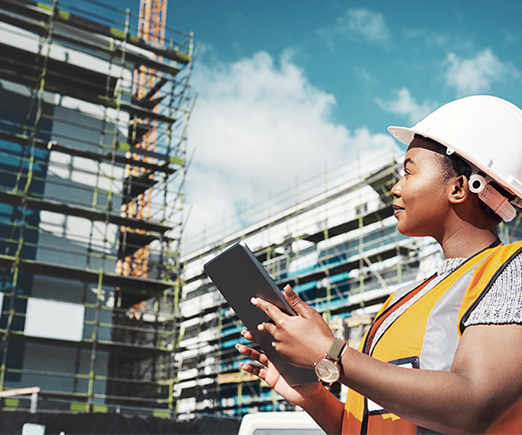  A worker noting something while seeing buildings