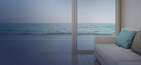 A sea view from a room's french window. 