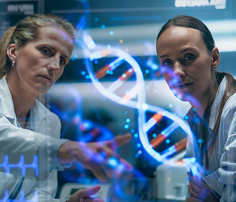 Two healthcare professionals looking at a projection of a DNA on a screen in a lab 