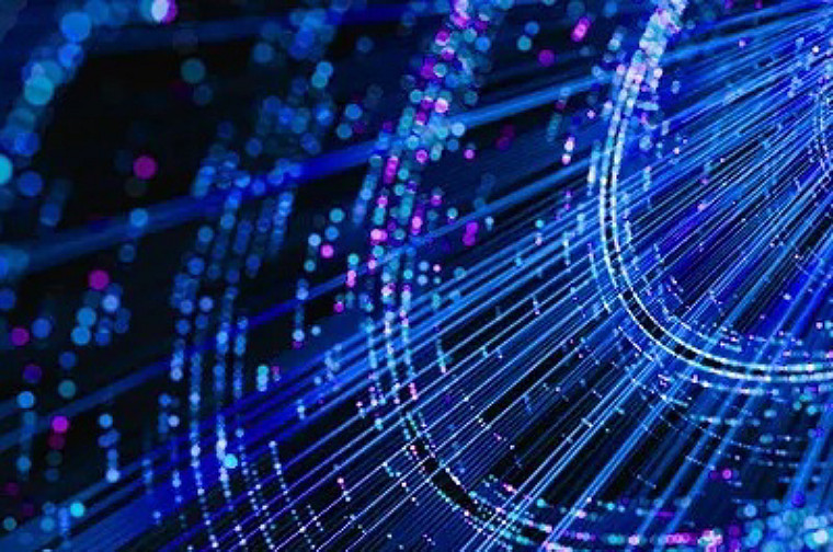 Abstract digital illustration of glowing blue and pink light streaks and particles forming flowing lines against a dark background, evoking data or network connectivity.