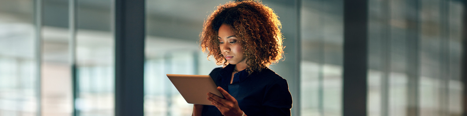 A woman looking at a tablet  