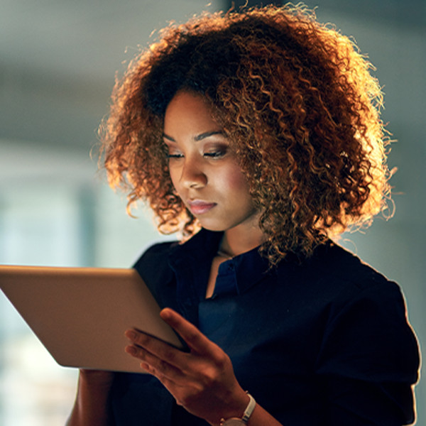 woman looking at tablet