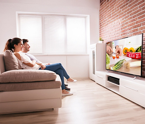 A couple watching TV in a living room