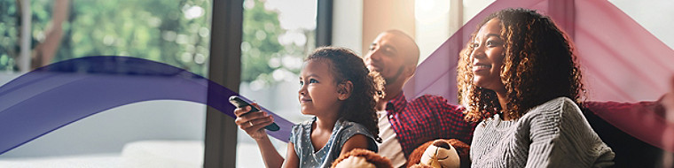 A family of three watching TV at home