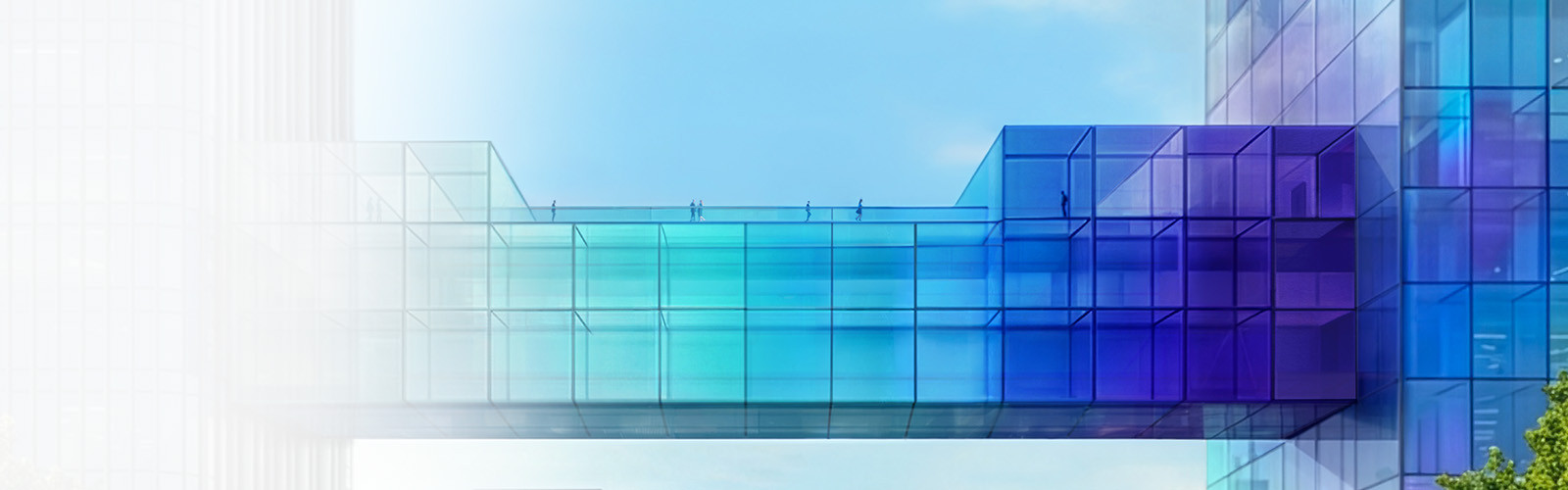 A modern transparent bridge connecting two buildings