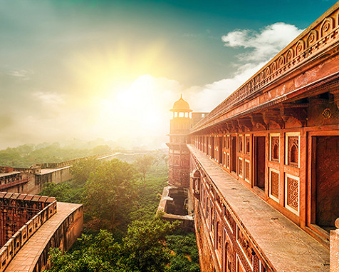 The rising sun as seen over a building