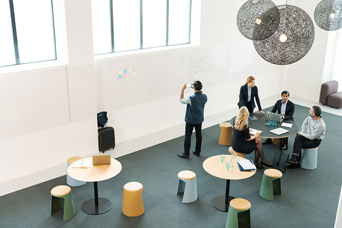 aerial view of an open room with colleagues engage in a discussion