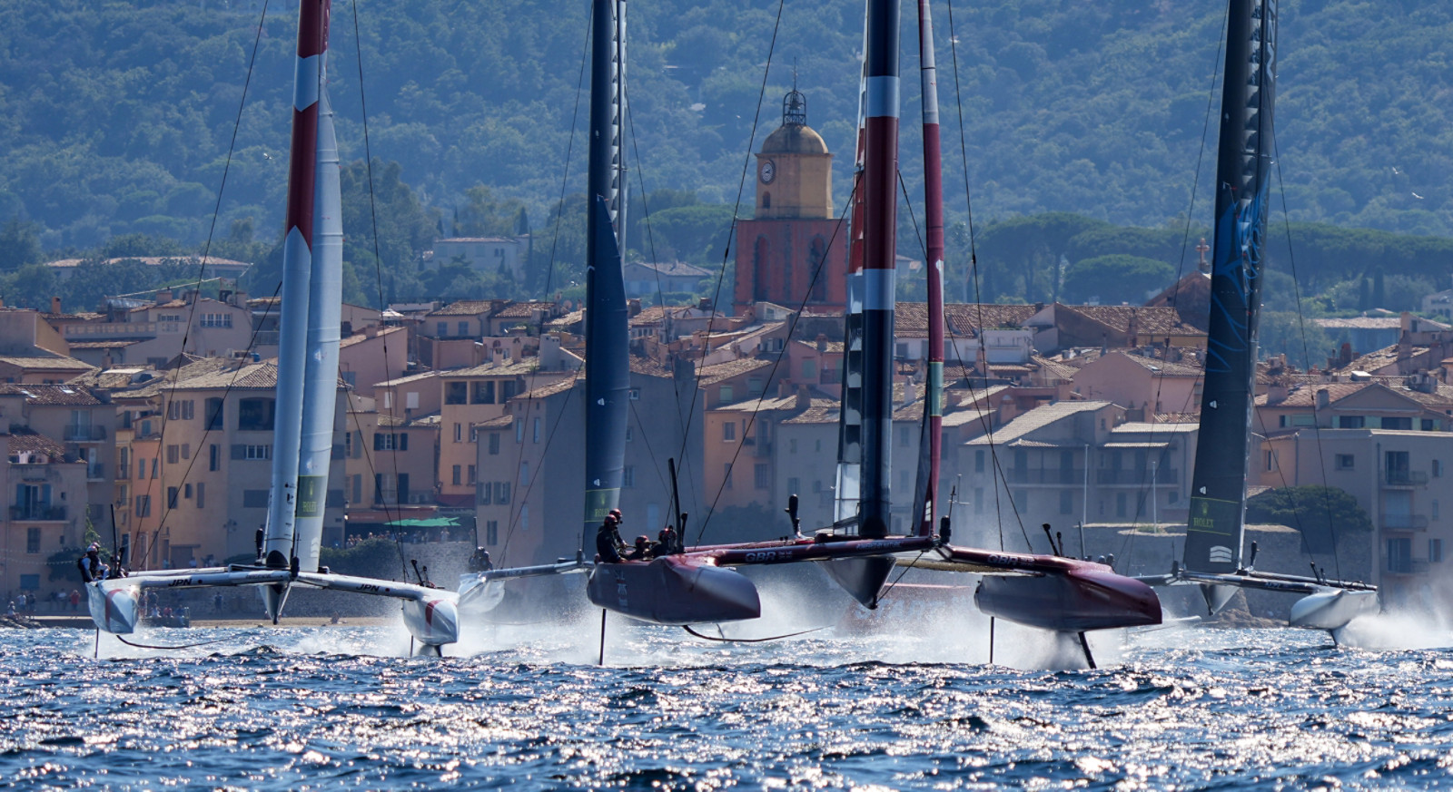 Great Britain SailGP Team helmed by Ben Ainslie leads Japan SailGP Team, USA SailGP Team and New Zealand SailGP Team away from the old town of Saint-Tropez on Race Day 1. France SailGP, Event 5, Season 2 in Saint-Tropez, France. 11 September 2021. Photo: Bob Martin for SailGP. Handout image supplied by SailGP
