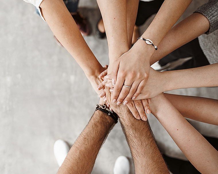 An overhead view of a team hand-stack or huddle