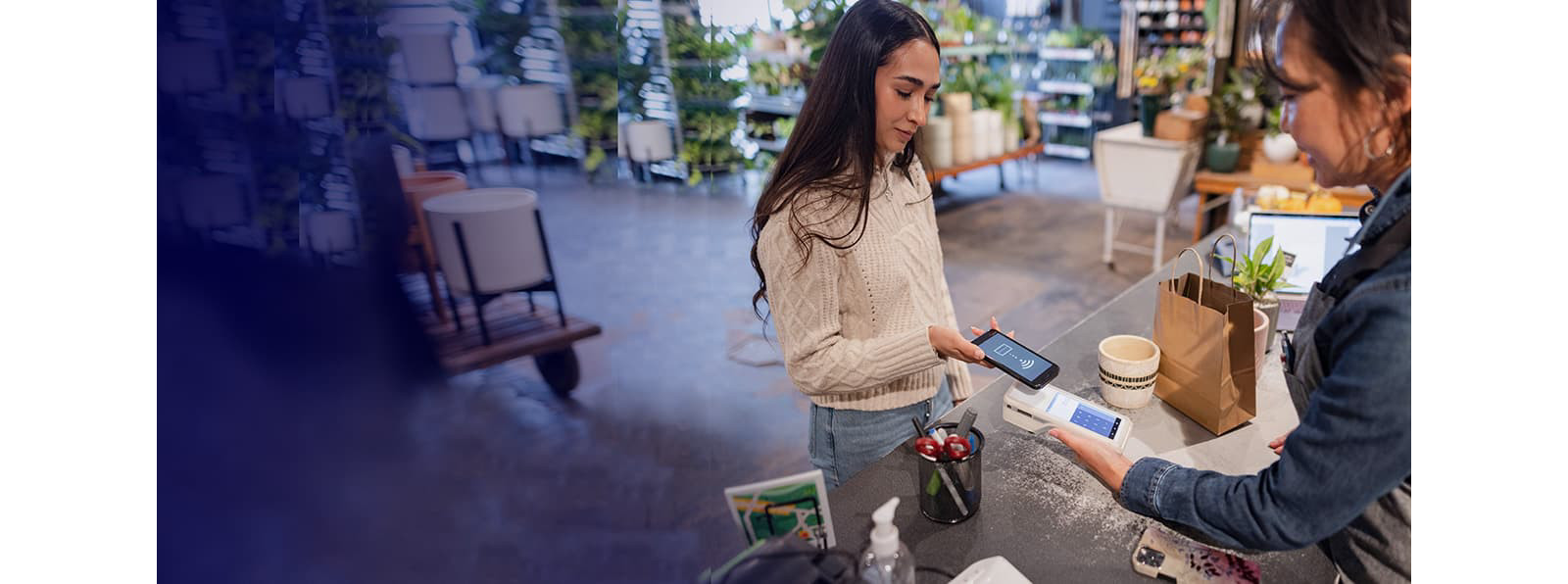 A woman making a digital payment through her mobile phone