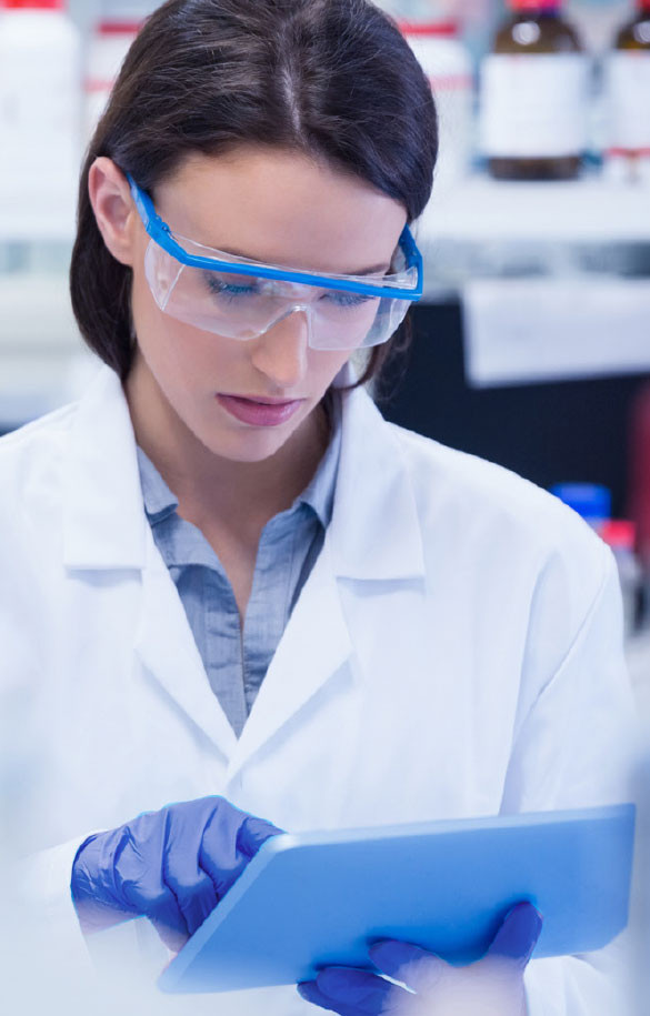 Medical technician working on tablet in PPE