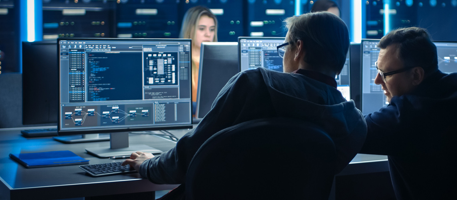 Two males discussing and looking at computer screen