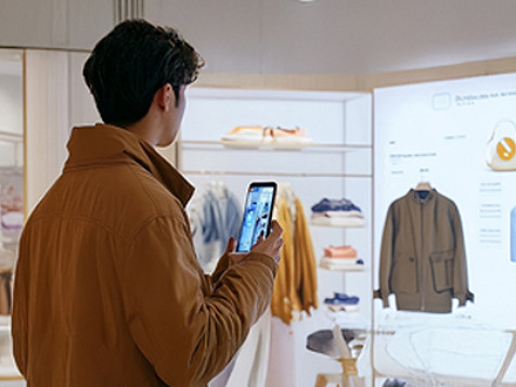 A man on a video call on his phone while shopping.