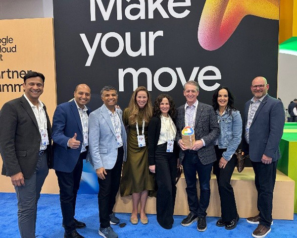A team standing on a stage at an event
