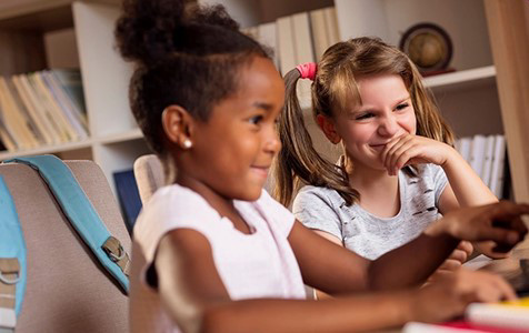 Two girls looking at a laptop