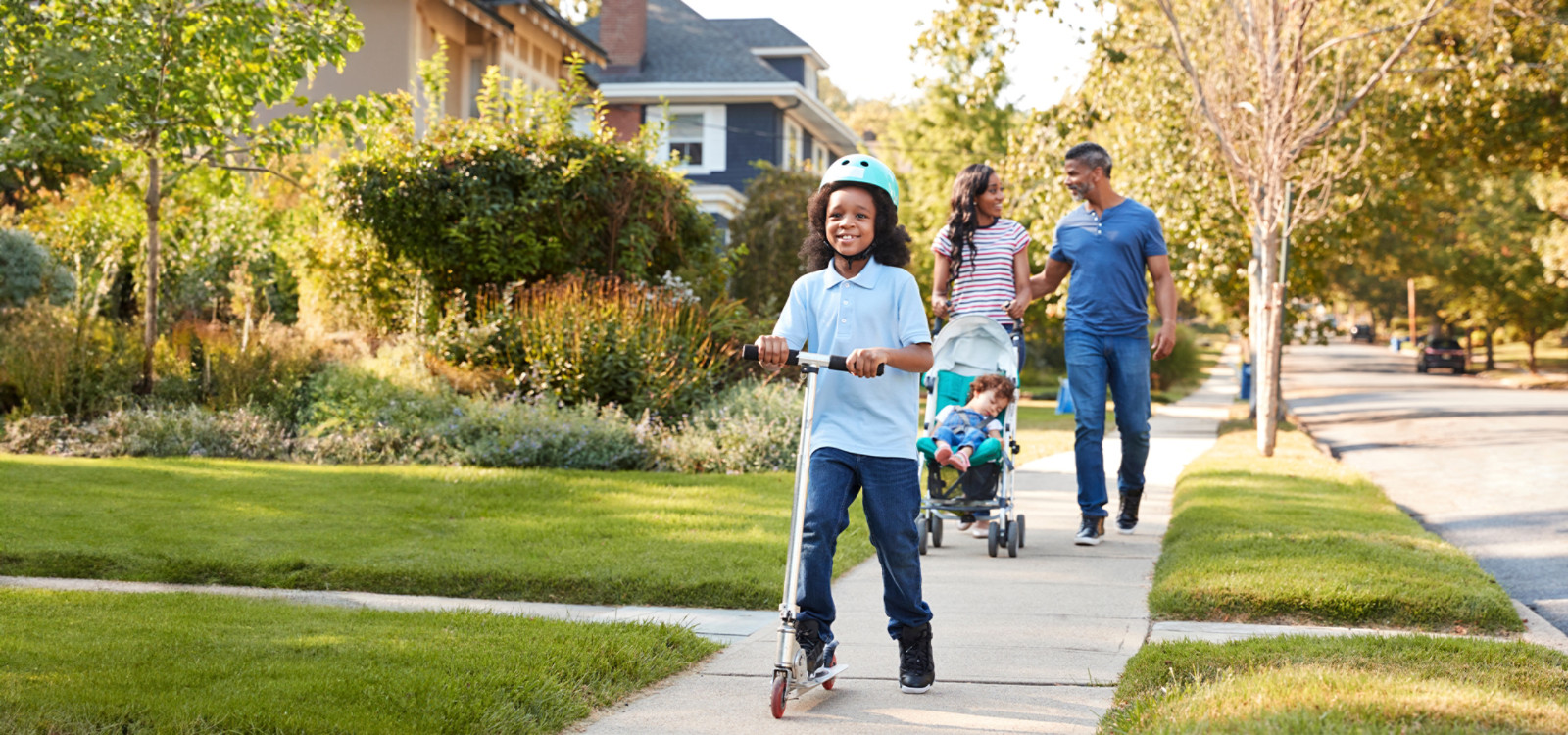 family walking down a suburban sidewalk