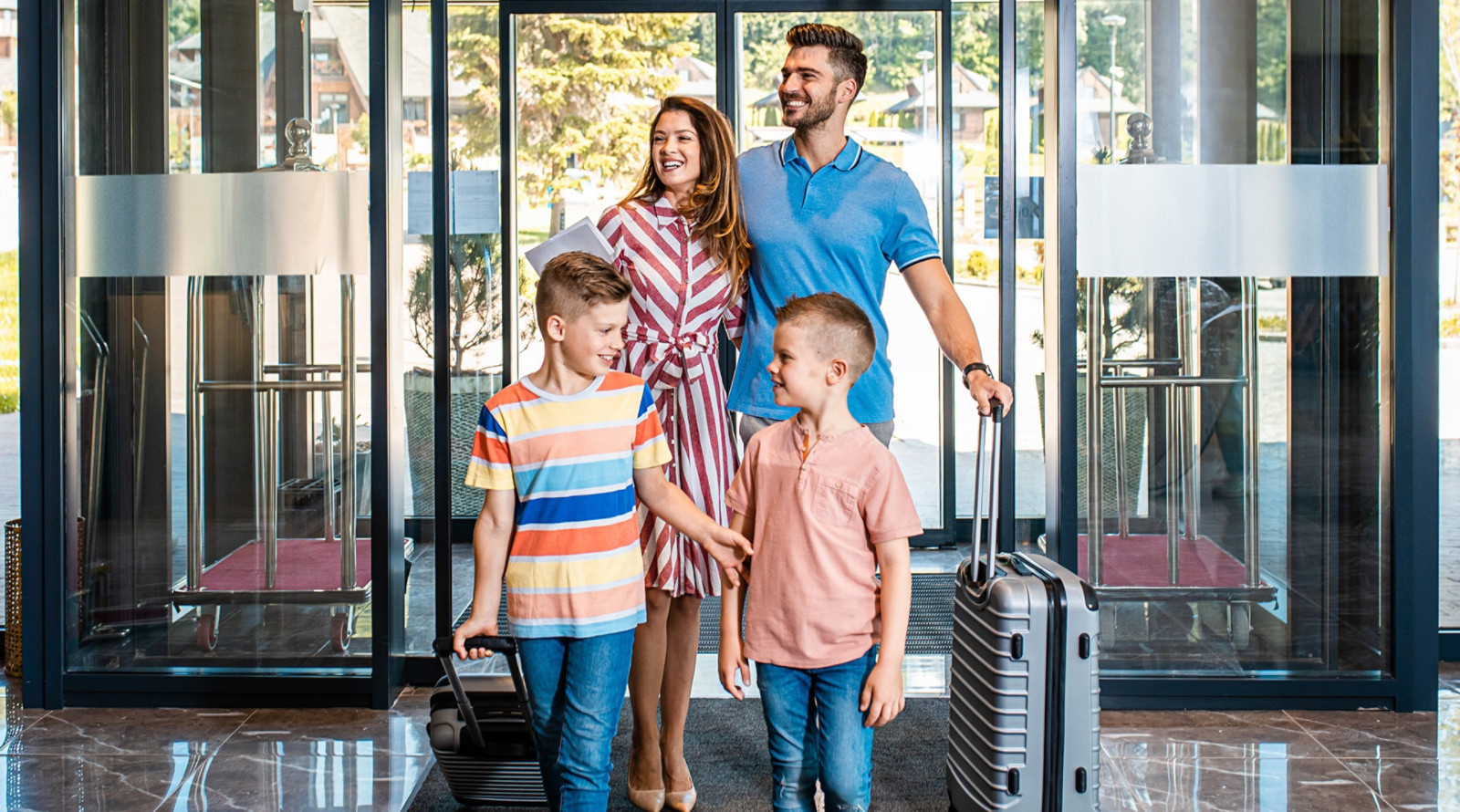 family checking into hotel