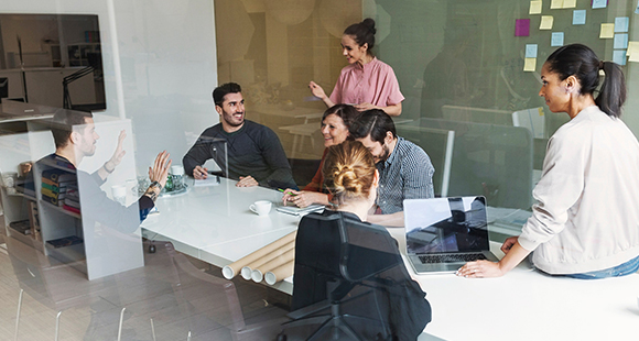 colleagues in a meeting room setting having a discussion