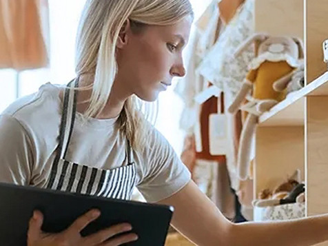 A women holding tab and checking something