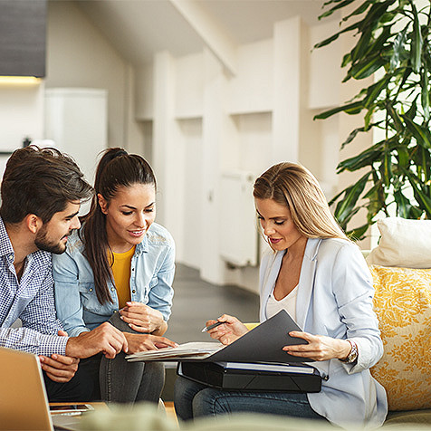 three employees discussing file