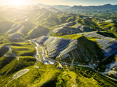 sky view of a solar panels on side of mountains