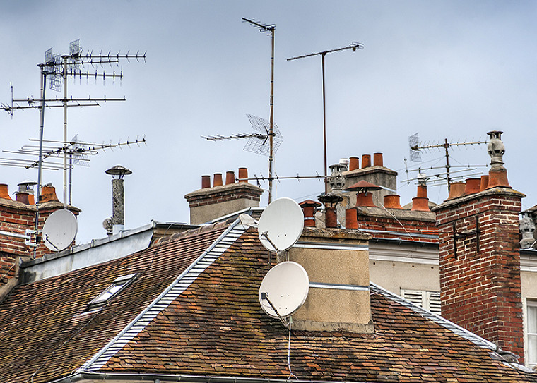 Dish antennas on a home rooftop