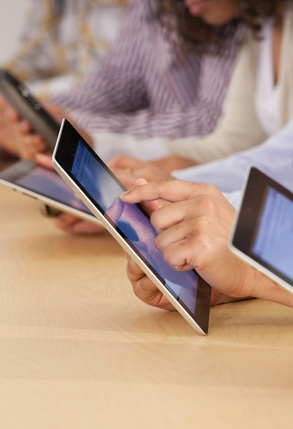 Fingers pointing a digital tablet