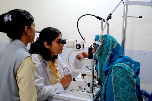 A doctor examing the eyes of a patient