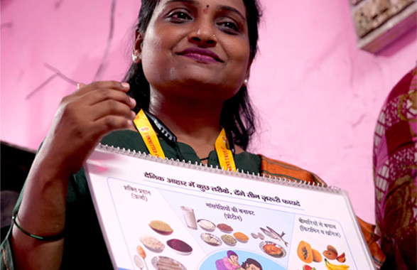 A healthcare worker giving instruction to pregnant women on nutrition