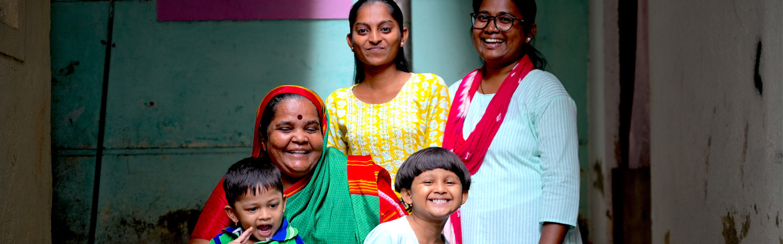 a girl beneficiary with her family