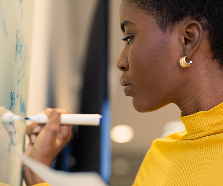 woman writing something on a board