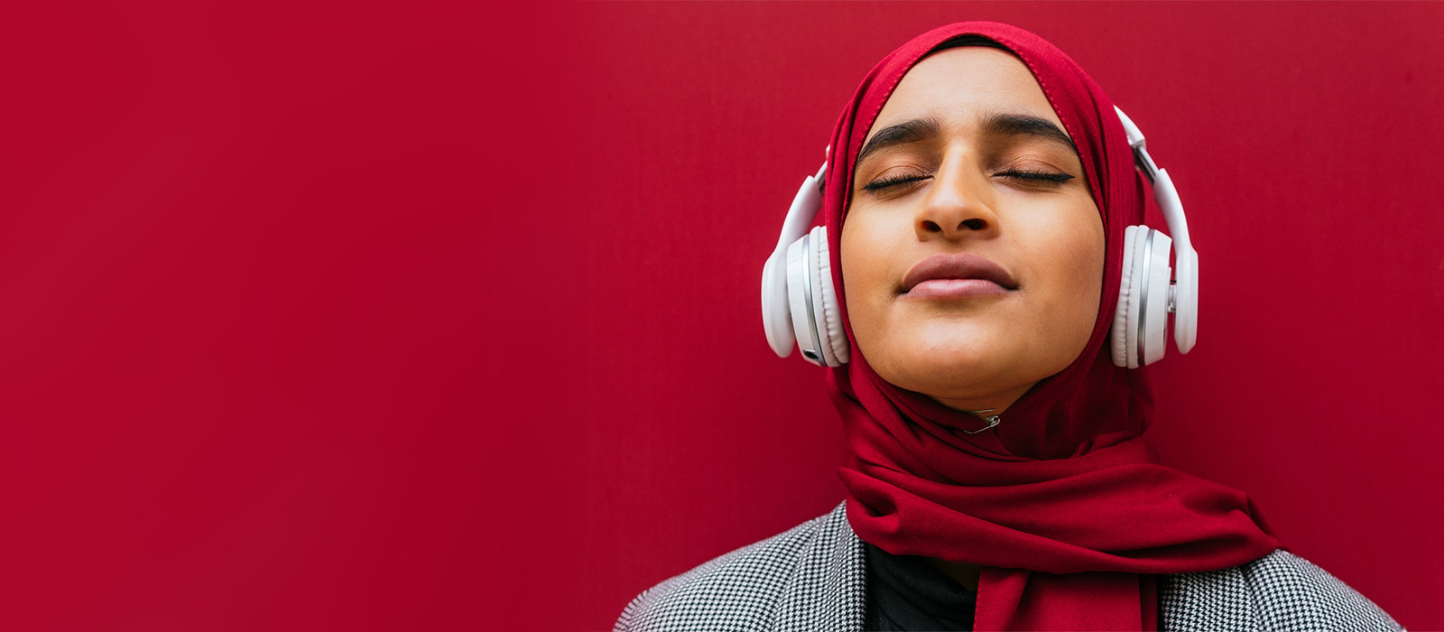 Woman with eyes closed, listening to music