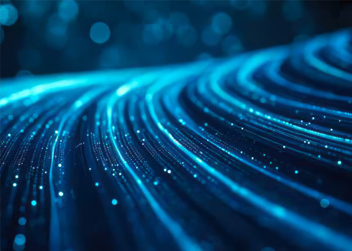 Abstract blue digital network with glowing data streams and particles, symbolizing AI and data flow.