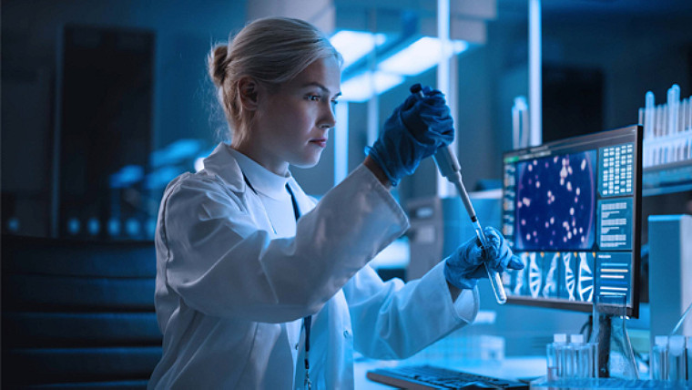 medical practitioner at work with a test tube in hand