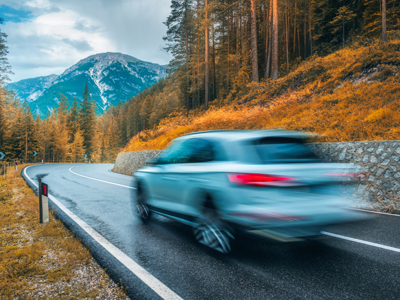View of a silver car driving by.