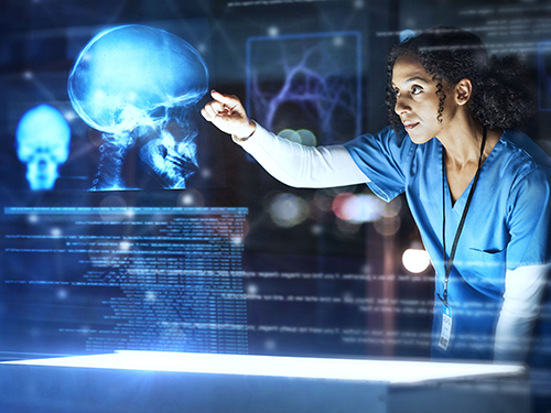 A female healthcare worker interacting with a digital interactive transparent screen