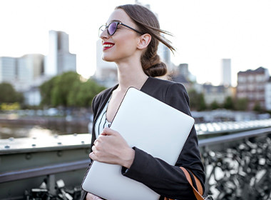 lady walking with her laptop