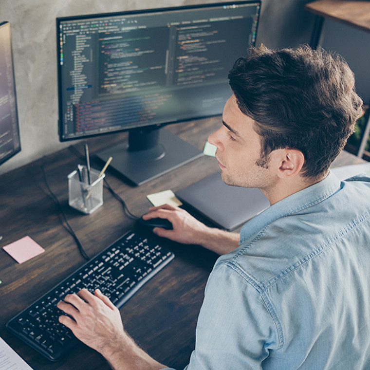 Top above high angle view portrait of his, he nice attractive focused skilled geek guy typing bug track report cyberspace security at modern industrial interior style concrete wall work place station